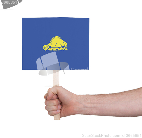 Image of Hand holding small card - Flag of Oregon