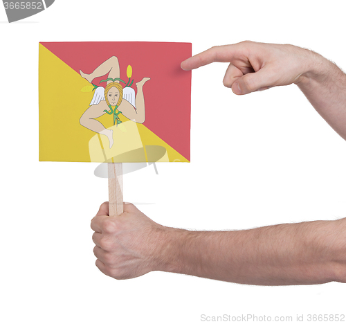 Image of Hand holding small card - Flag of Sicily