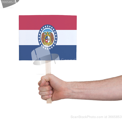 Image of Hand holding small card - Flag of Missouri