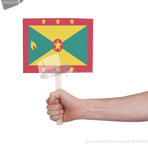 Image of Hand holding small card - Flag of Grenada