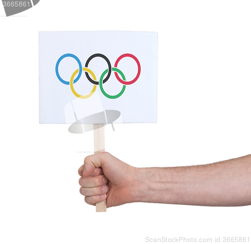 Image of Hand holding small card - Flag of the Olympic games