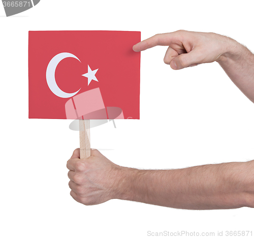 Image of Hand holding small card - Flag of Turkey