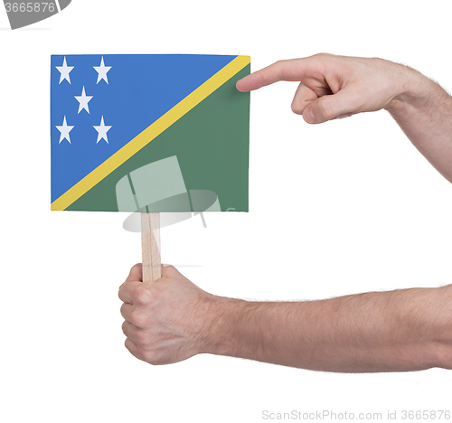 Image of Hand holding small card - Flag of Solomon Islands