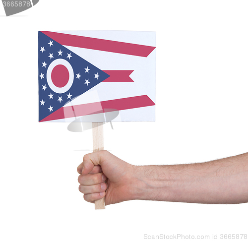 Image of Hand holding small card - Flag of Ohio