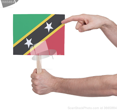 Image of Hand holding small card - Flag of Saint Kitts and Nevis