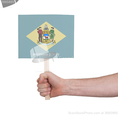 Image of Hand holding small card - Flag of Delaware