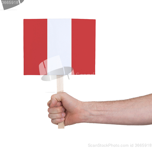 Image of Hand holding small card - Flag of Peru