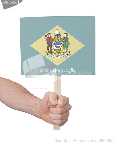 Image of Hand holding small card - Flag of Delaware