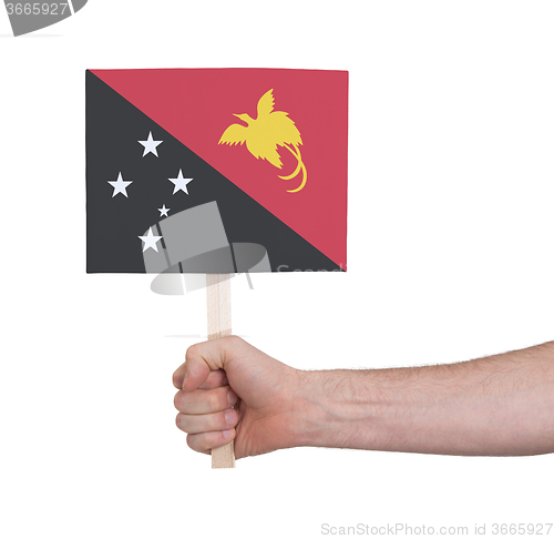 Image of Hand holding small card - Flag of Papua New Guinea