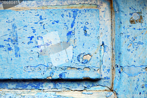 Image of stripped paint in   wood door and rusty  