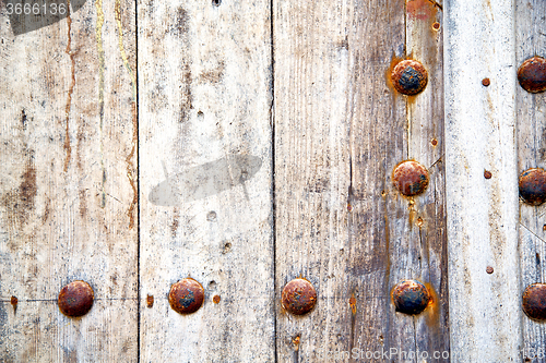 Image of metal nail dirty stripped paint in the 