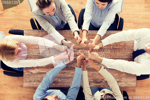 Image of business team showing thumbs up