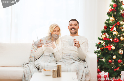 Image of happy couple at home with christmas tree