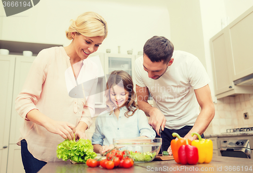 Image of happy family making dinner in kitchen