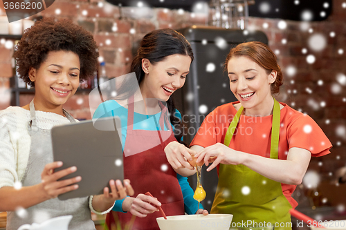 Image of happy women with tablet pc in kitchen