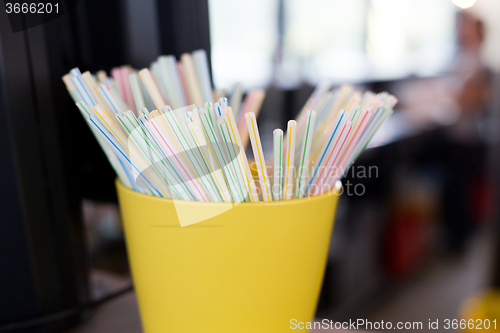 Image of close up of cocktail straws in glass at restaurant