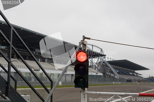 Image of red traffic lights and road sign on race track