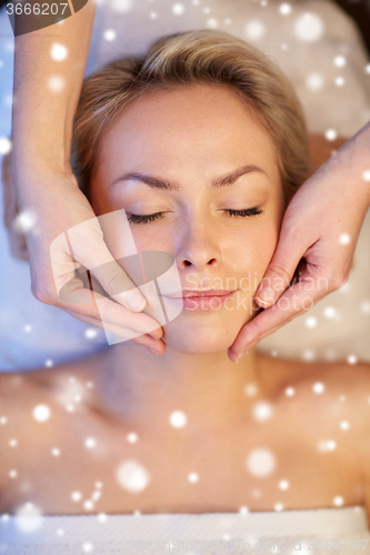 Image of close up of woman having face massage in spa salon