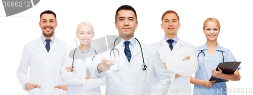Image of group of doctors with clipboard pointing at you
