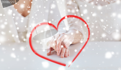 Image of close up of happy married lesbian couple hands