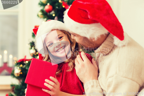 Image of smiling father and daughter opening gift box