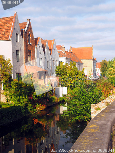 Image of medieval houses  canal tourist destination Bruges Brugge Belgium