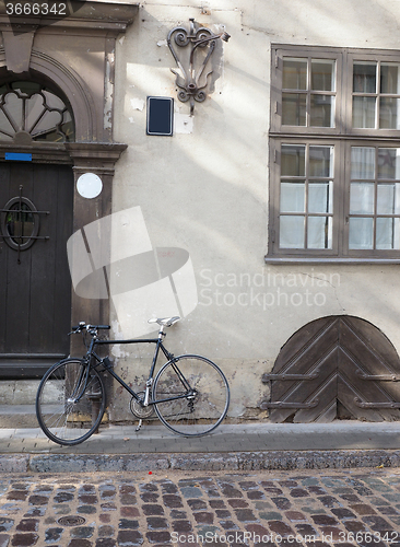 Image of cobblestone street with bicycle  medieval houses Riga Latvia Eur