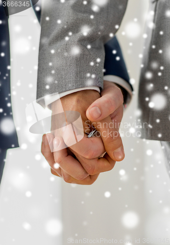 Image of close up of male gay couple holding hands