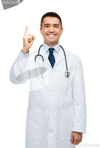 Image of happy male doctor in white coat pointing finger up