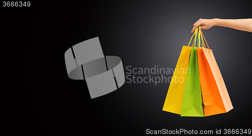 Image of close up of hand holding shopping bags