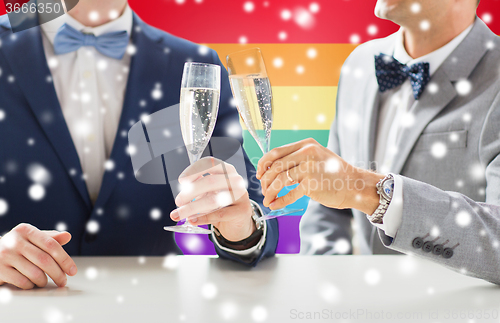 Image of close up of male gay couple with champagne glasses