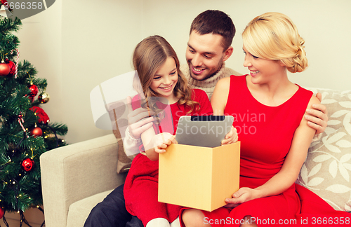 Image of smiling family with tablet pc