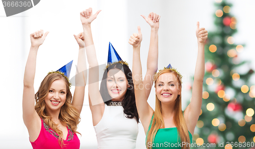 Image of three women wearing hats and showing thumbs up