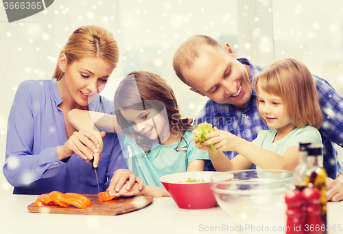 Image of happy family with two kids making dinner at home