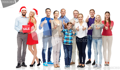 Image of happy people with sale sign showing thumbs up