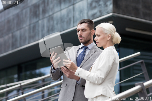 Image of businesspeople with tablet pc outdoors
