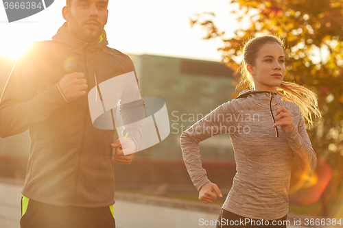 Image of couple running outdoors