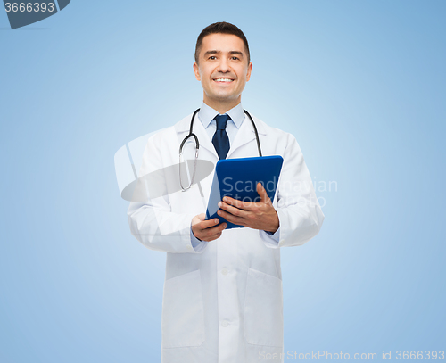 Image of smiling male doctor in white coat with tablet pc