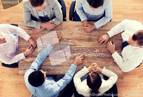 Image of close up of business team sitting at table