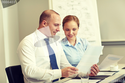 Image of smiling business people meeting in office