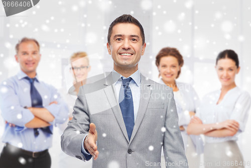 Image of happy smiling businessman in suit shaking hand