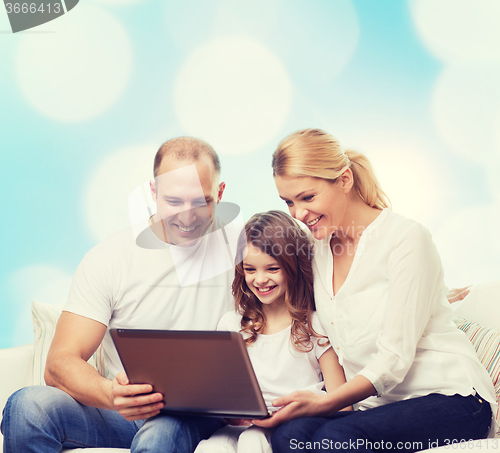 Image of smiling family with laptop