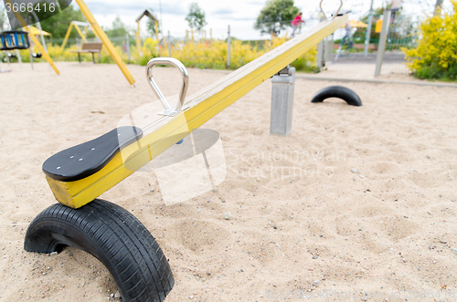 Image of close up of swing or teeterboard on playground 