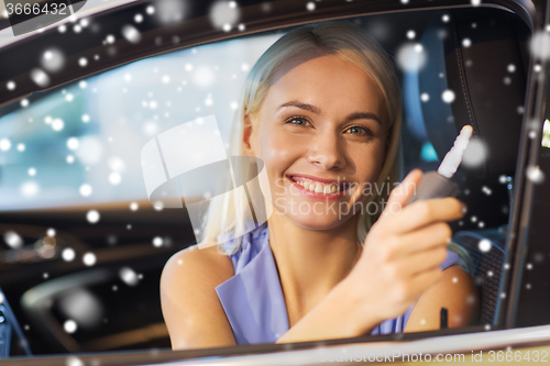 Image of happy woman getting car key in auto show or salon