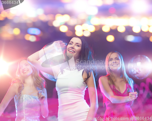 Image of happy women dancing at night club