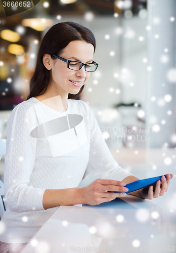 Image of smiling woman with tablet pc at cafe