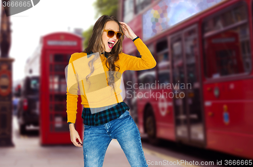 Image of happy young woman or teen over london city street