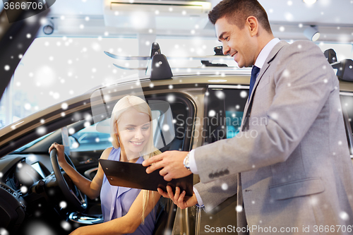 Image of happy woman with car dealer in auto show or salon