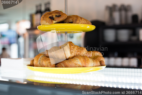 Image of close up of croissants and buns on cake stand