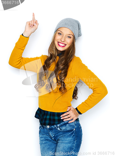 Image of happy young woman or teen girl pointing finger up